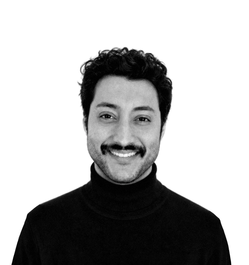 Shree Chaturvedi, smiling, rendered as a noir-graded studio portrait